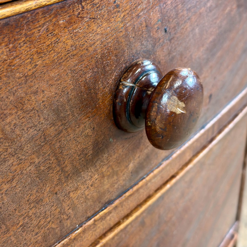 An antique mahogany bow front chest of drawers with two short drawers over three long graduated drawers, turned wooden handles, and turned feet. View IX