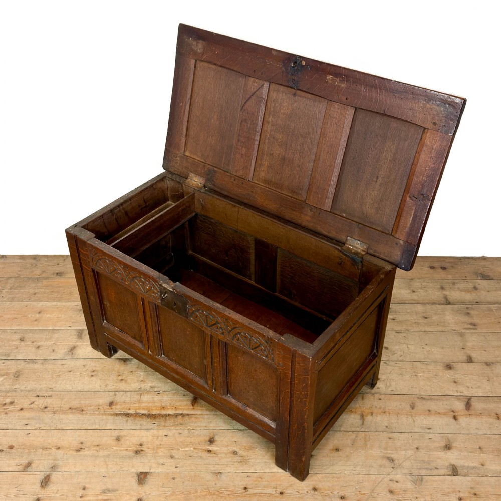 A dark oak coffer with three carved lunette frieze panels above recessed lower panels and an iron lock plate. View IV