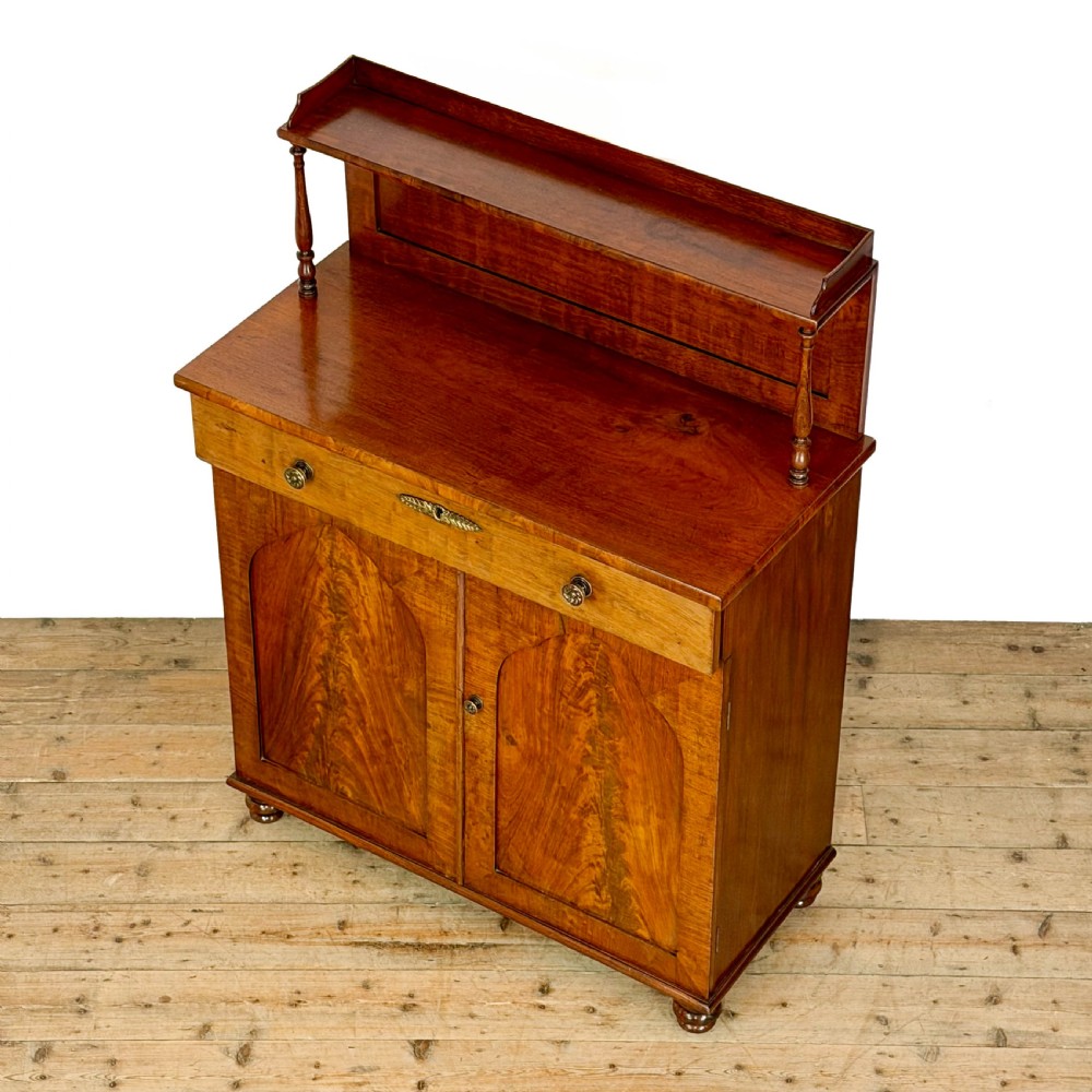 A Victorian mahogany chiffonier sideboard featuring a raised back shelf on turned supports, a frieze drawer with brass hardware, and two arched cupboard doors. View II