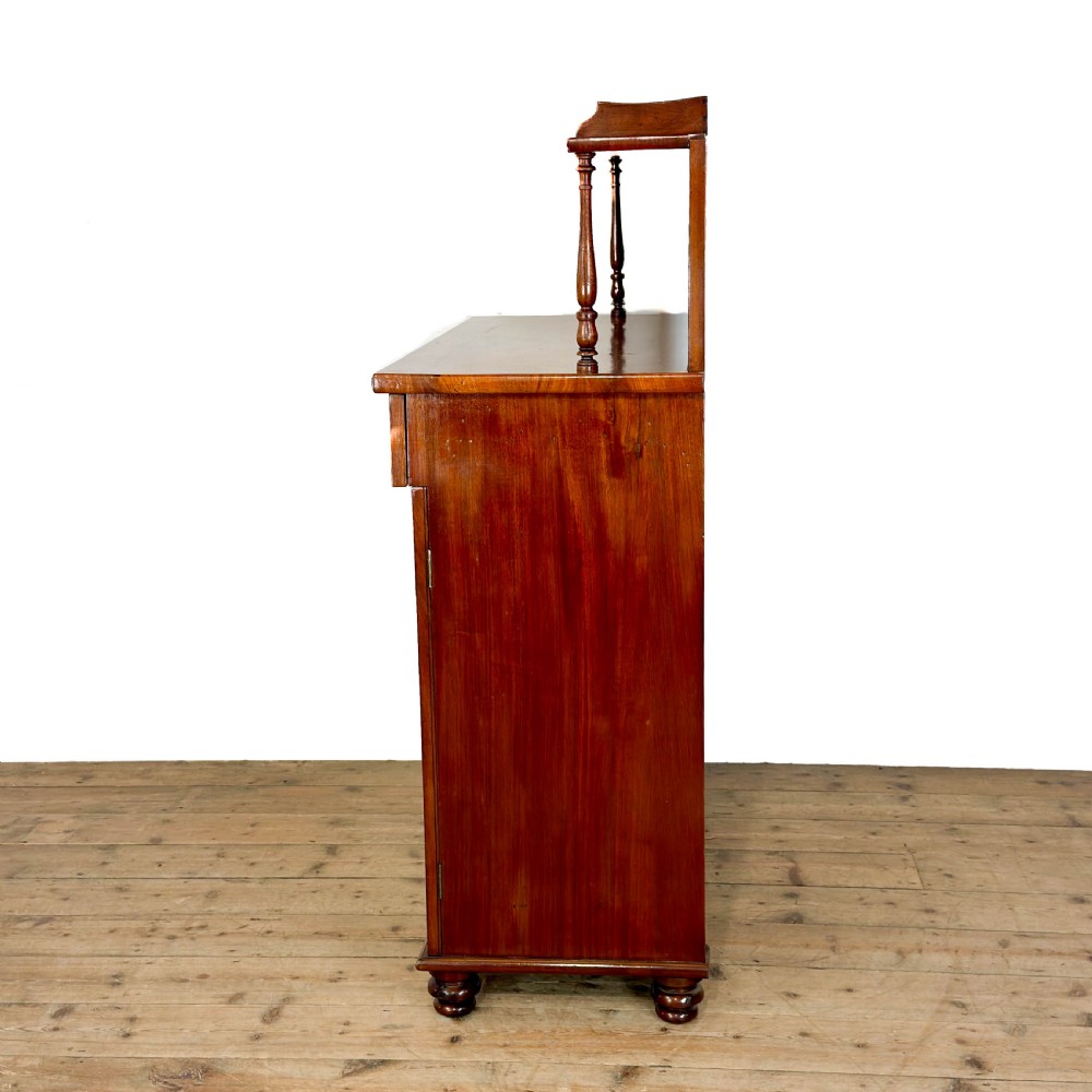 A Victorian mahogany chiffonier sideboard featuring a raised back shelf on turned supports, a frieze drawer with brass hardware, and two arched cupboard doors. View III