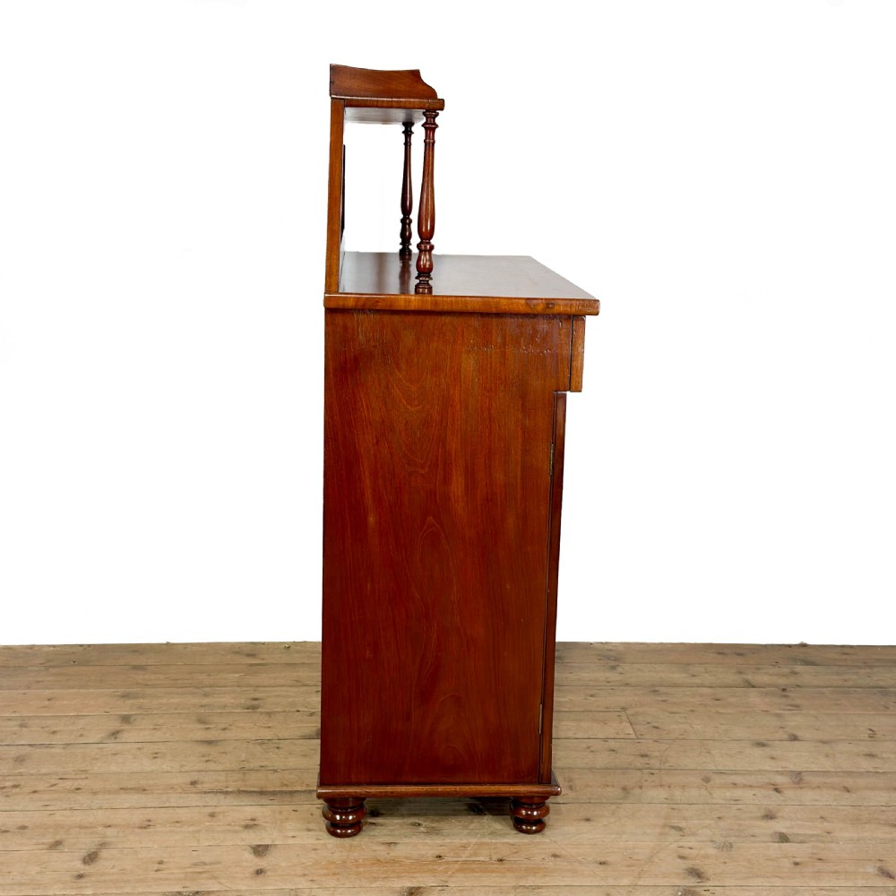A Victorian mahogany chiffonier sideboard featuring a raised back shelf on turned supports, a frieze drawer with brass hardware, and two arched cupboard doors. View V