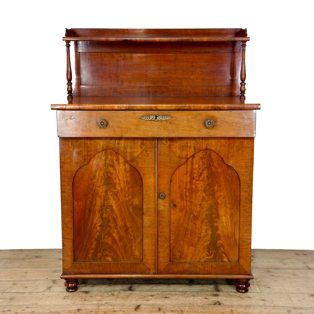 A Victorian mahogany chiffonier sideboard featuring a raised back shelf on turned supports, a frieze drawer with brass hardware, and two arched cupboard doors. View VIII