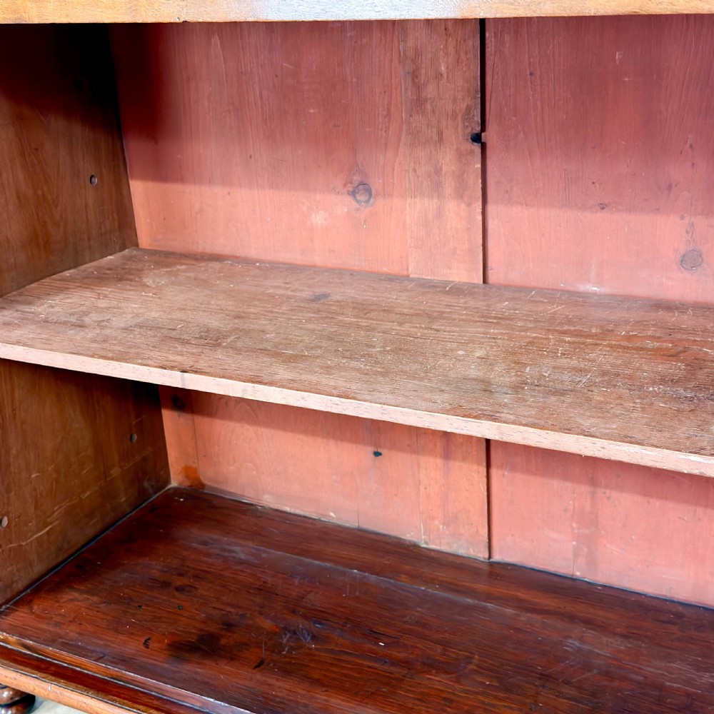 A Victorian mahogany chiffonier sideboard featuring a raised back shelf on turned supports, a frieze drawer with brass hardware, and two arched cupboard doors. View X
