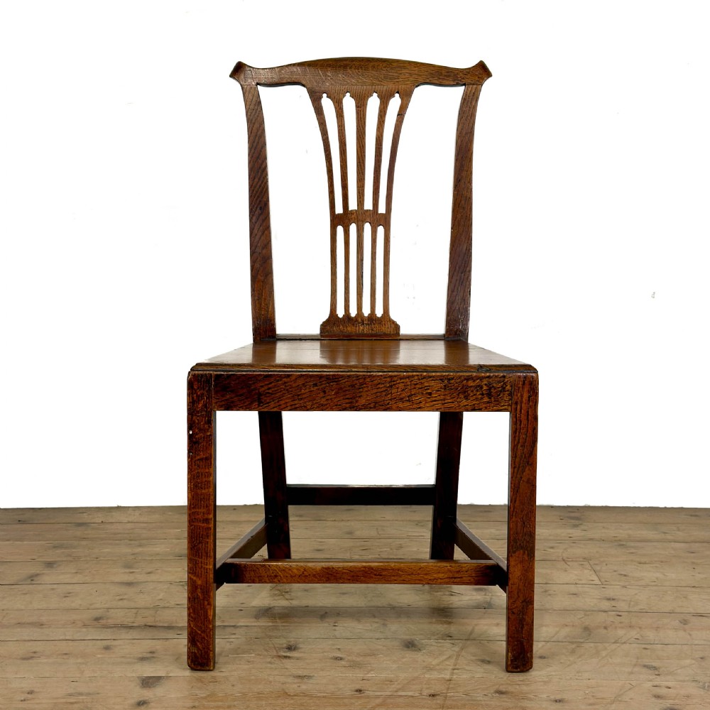 A set of six medium brown antique oak dining chairs featuring vertical splat backs, solid wooden seats, and stretcher bases. View III