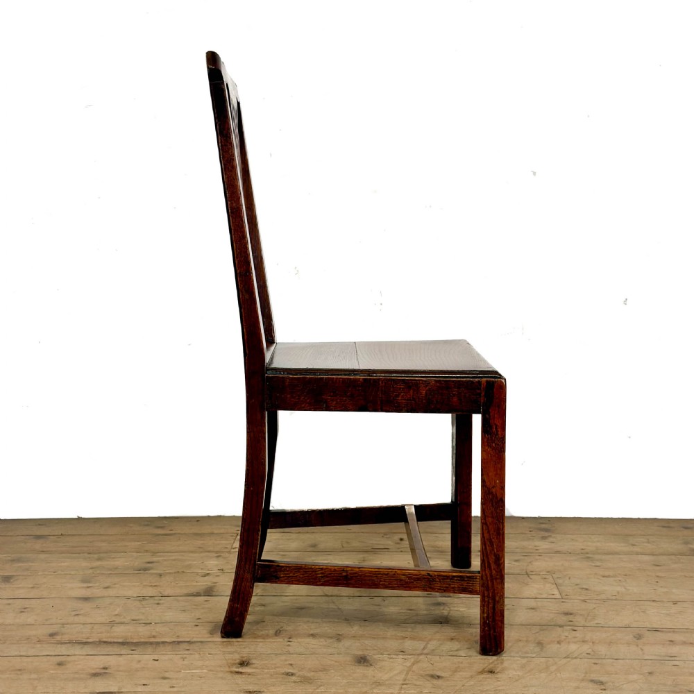 A set of six medium brown antique oak dining chairs featuring vertical splat backs, solid wooden seats, and stretcher bases. View VII