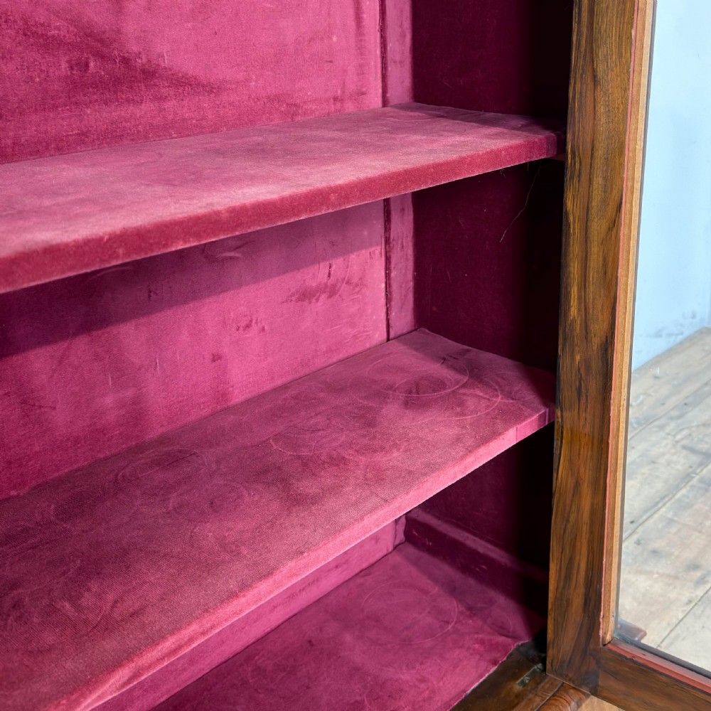 A Victorian walnut pier cabinet featuring floral marquetry inlays, gilt metal mounts, a single glazed door, and a red fabric-lined interior with two shelves. View IV