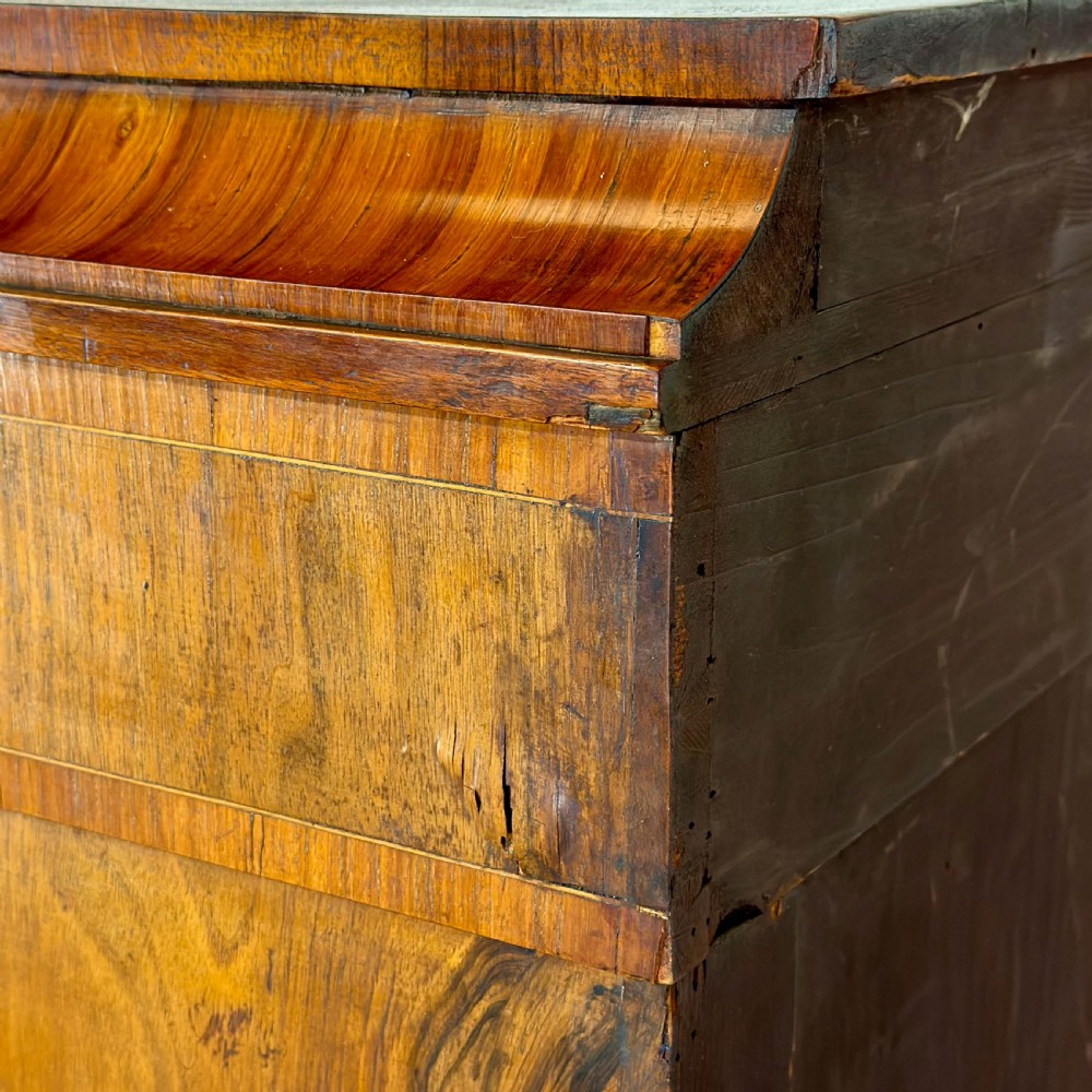 A Victorian walnut pier cabinet featuring floral marquetry inlays, gilt metal mounts, a single glazed door, and a red fabric-lined interior with two shelves. View VI