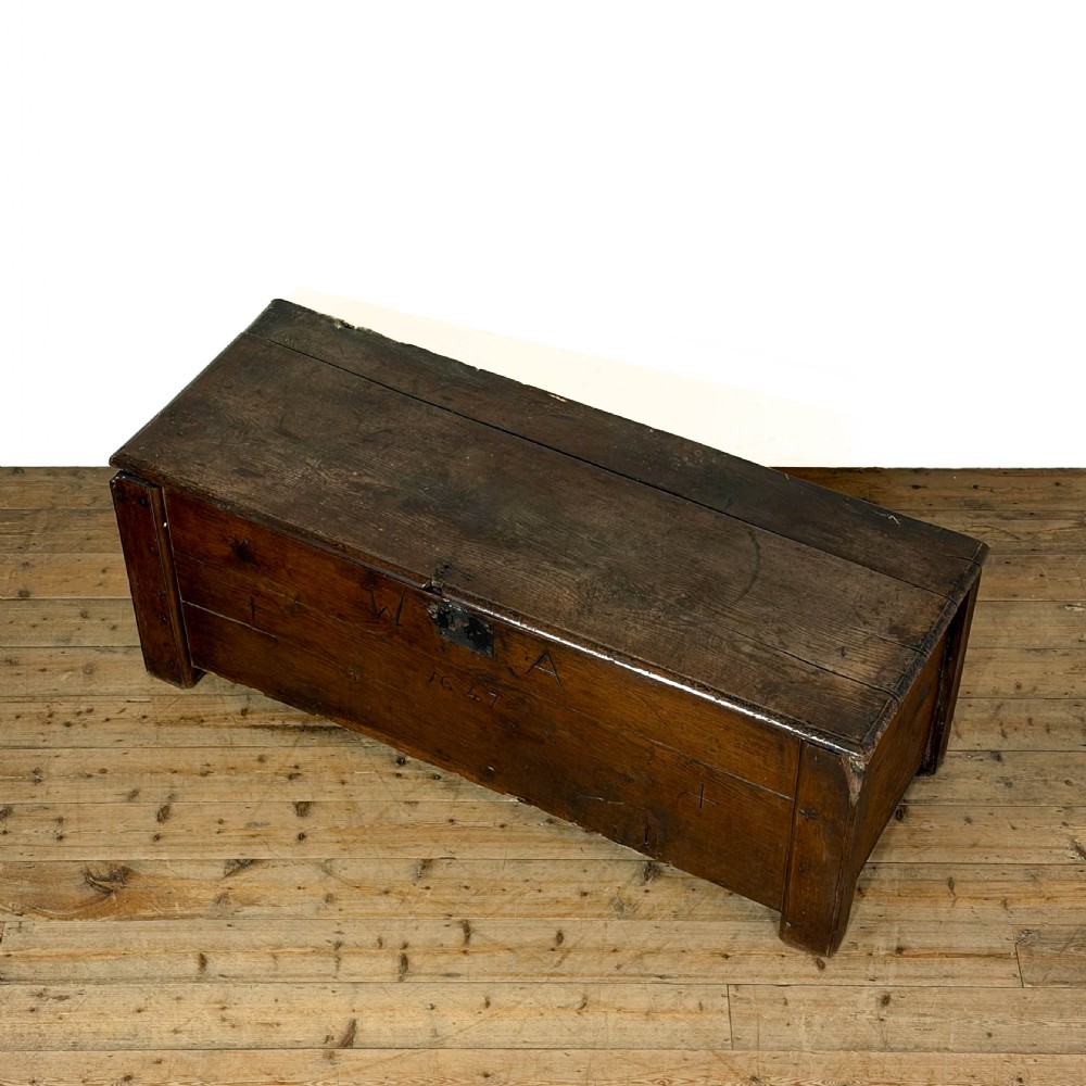 A large dark oak coffer featuring the carved initials W A, the date 1647, two small carved crosses, and a central iron lockplate. View IV