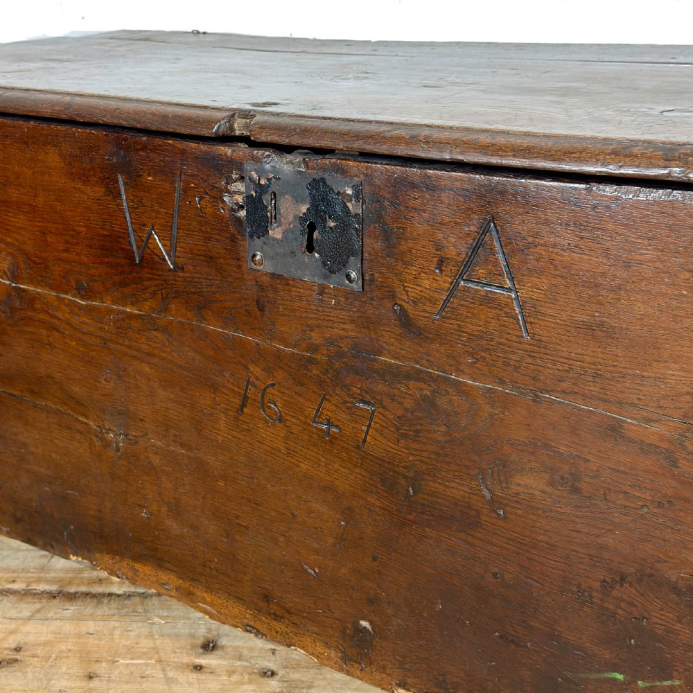 A large dark oak coffer featuring the carved initials W A, the date 1647, two small carved crosses, and a central iron lockplate. View VI