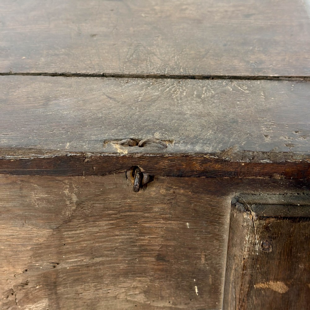A large dark oak coffer featuring the carved initials W A, the date 1647, two small carved crosses, and a central iron lockplate. View XI