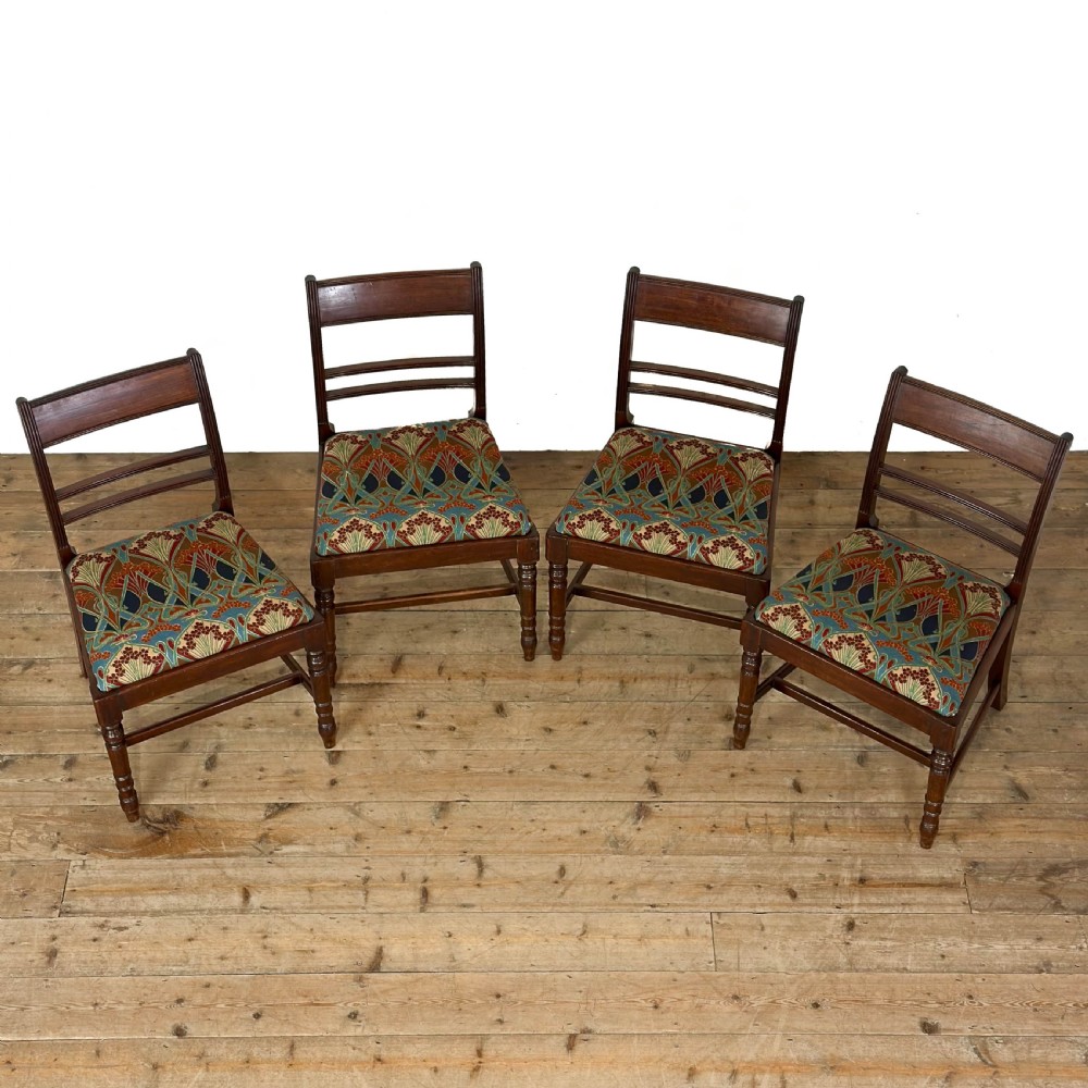 Set of four antique mahogany dining chairs with horizontal bar backs, turned front legs, and patterned drop-in upholstered seats. View II