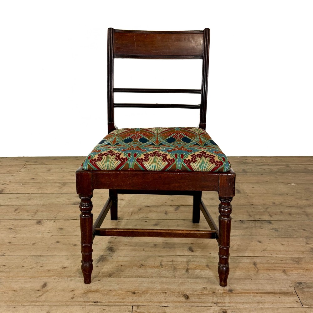 Set of four antique mahogany dining chairs with horizontal bar backs, turned front legs, and patterned drop-in upholstered seats. View IV