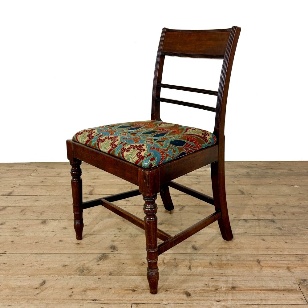 Set of four antique mahogany dining chairs with horizontal bar backs, turned front legs, and patterned drop-in upholstered seats. View V