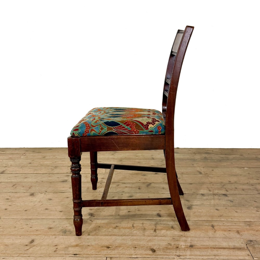 Set of four antique mahogany dining chairs with horizontal bar backs, turned front legs, and patterned drop-in upholstered seats. View VI