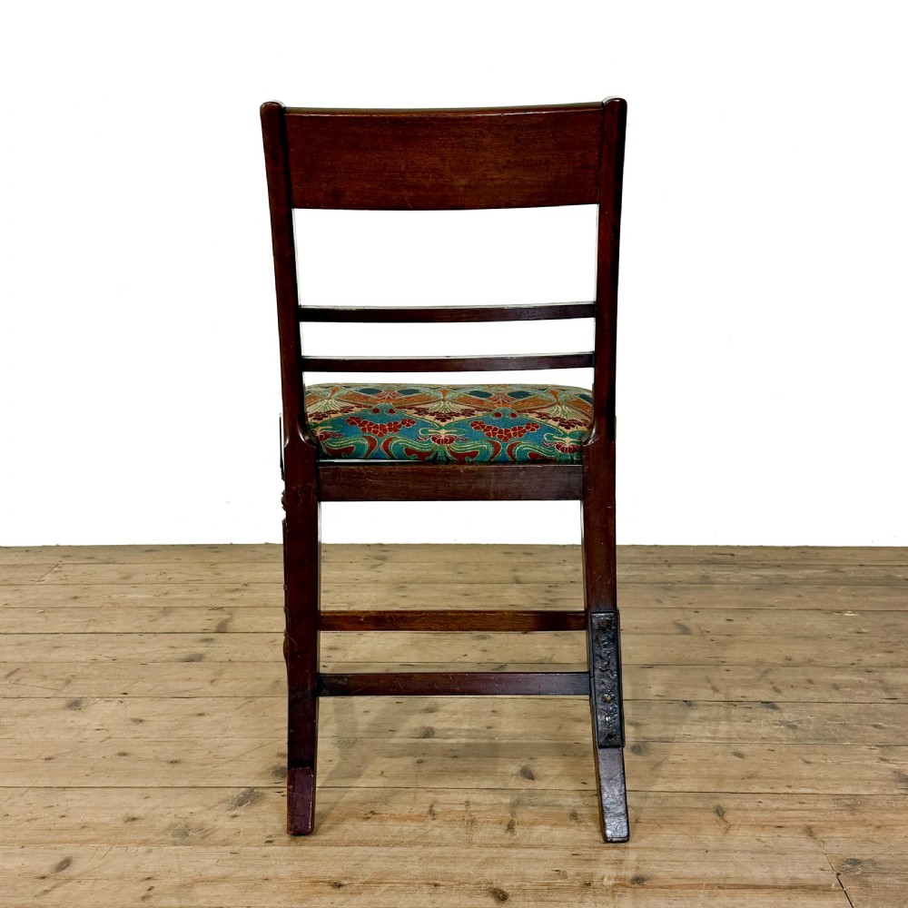 Set of four antique mahogany dining chairs with horizontal bar backs, turned front legs, and patterned drop-in upholstered seats. View VII