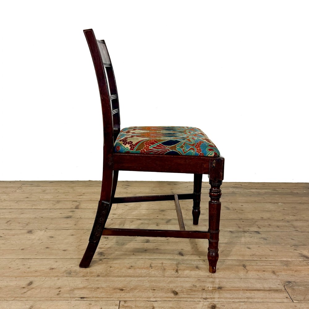 Set of four antique mahogany dining chairs with horizontal bar backs, turned front legs, and patterned drop-in upholstered seats. View VIII