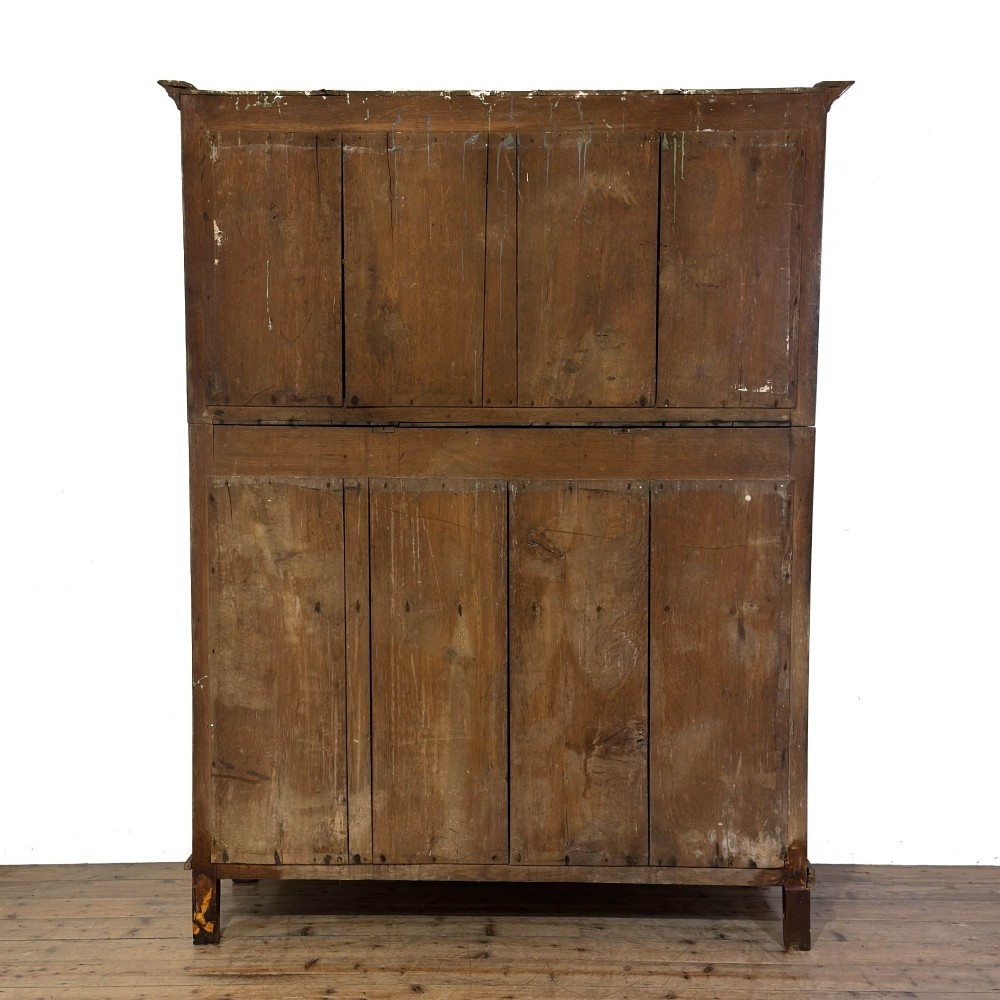 An 18th-century dark oak Welsh cwpwrdd deuddarn cupboard featuring two tiers with arched panelled doors and three lower drawers. View VI