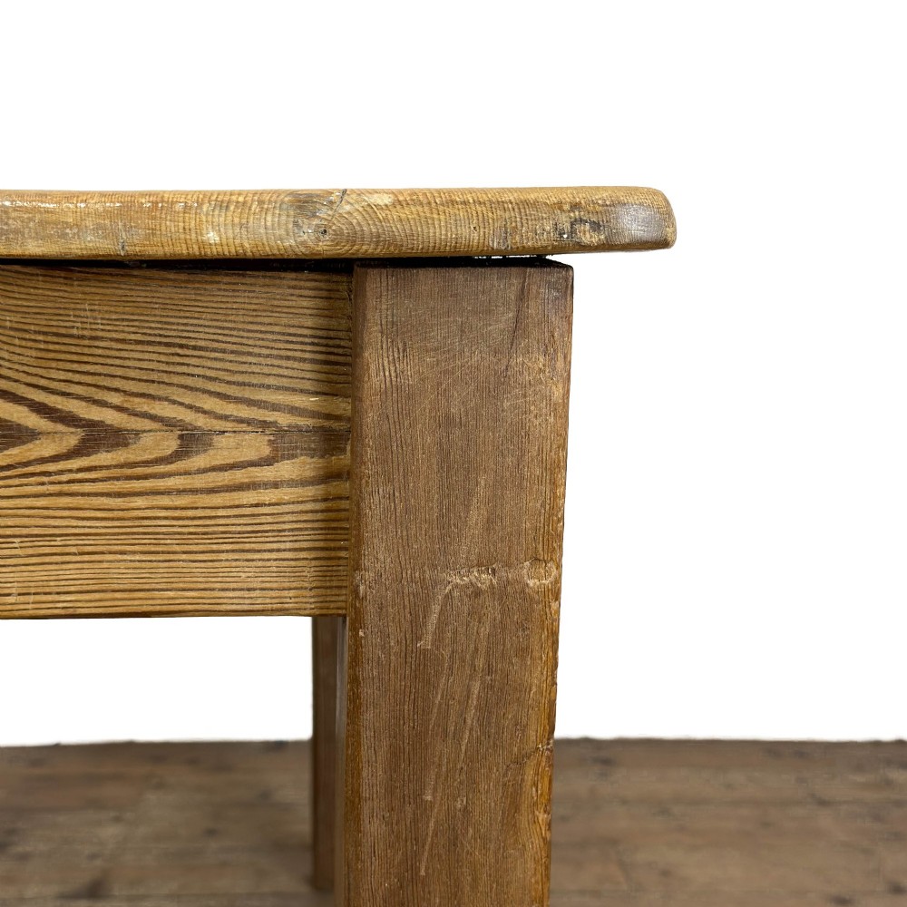 A rustic pine kitchen table featuring a single frieze drawer with a round wooden knob handle and four straight legs. View V