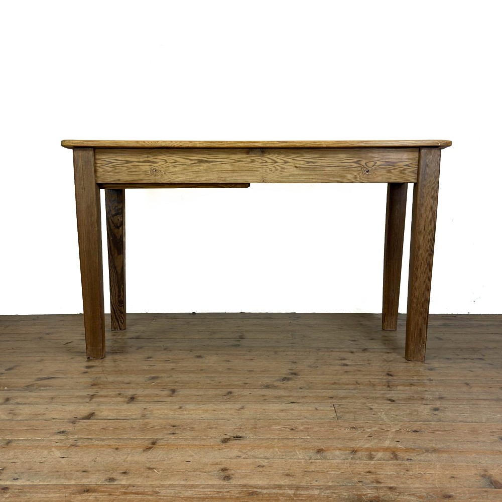 A rustic pine kitchen table featuring a single frieze drawer with a round wooden knob handle and four straight legs. View VI