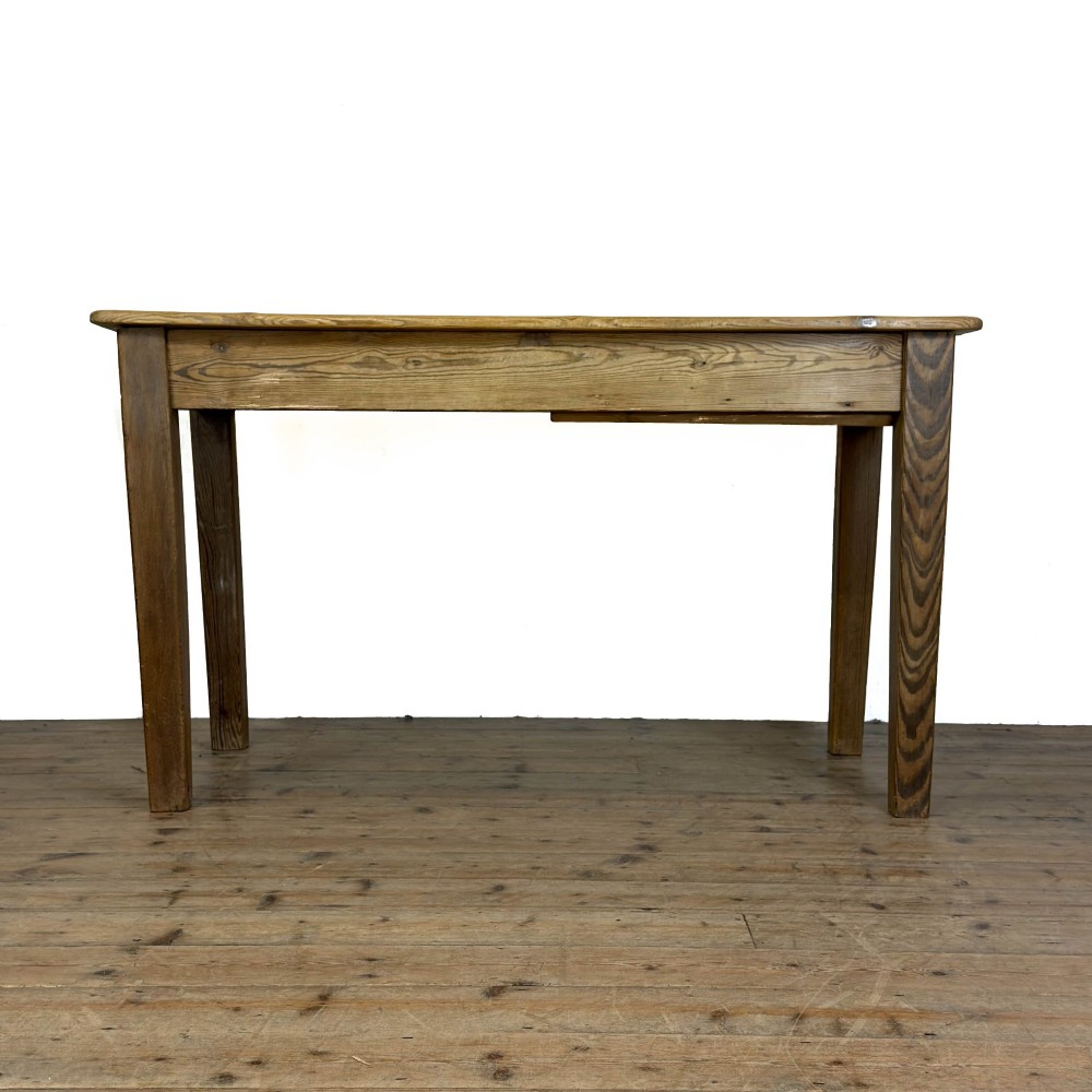 A rustic pine kitchen table featuring a single frieze drawer with a round wooden knob handle and four straight legs. View VII