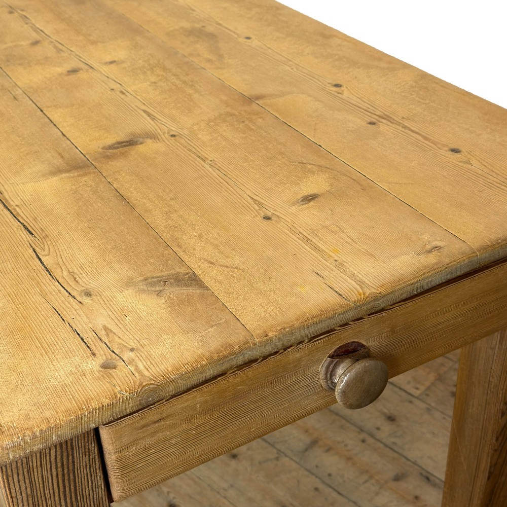 A rustic pine kitchen table featuring a single frieze drawer with a round wooden knob handle and four straight legs. View VIII