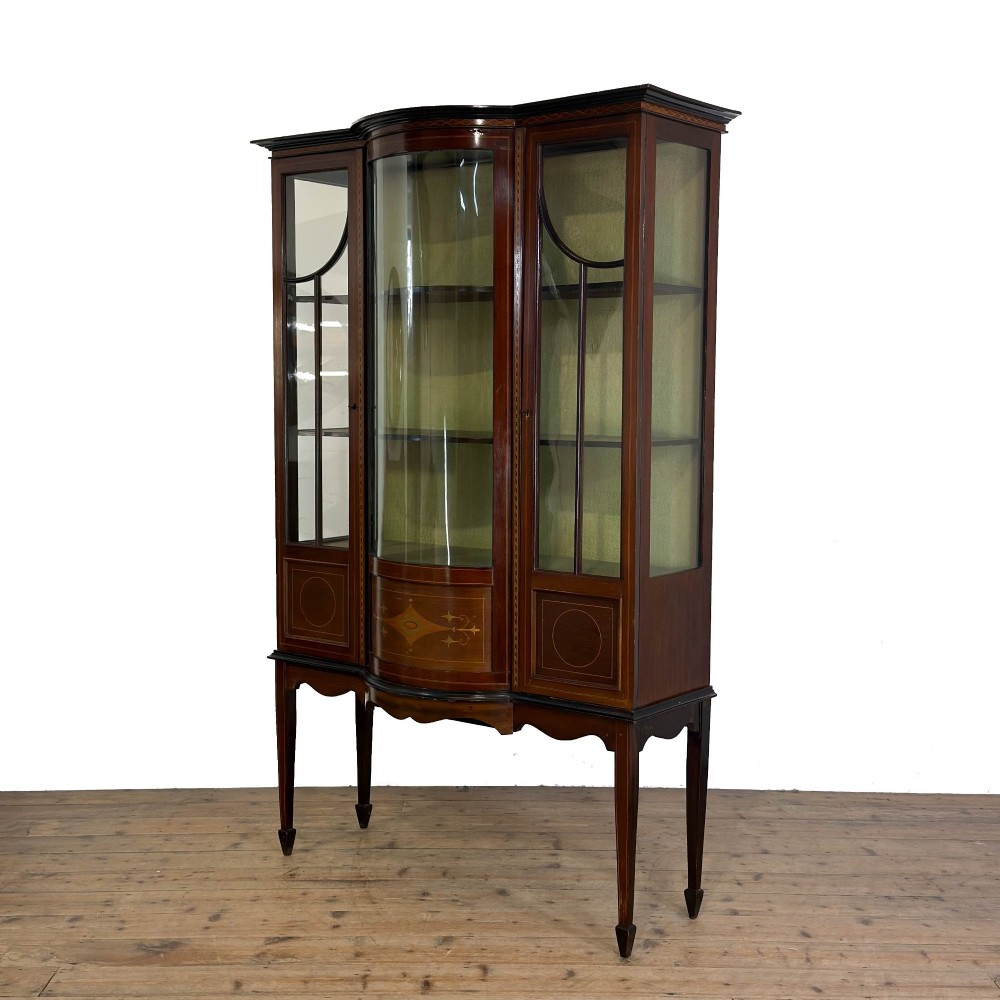 An Edwardian mahogany display cabinet featuring a central bow-front glazed door with marquetry inlay flanked by two side glazed panels. View III