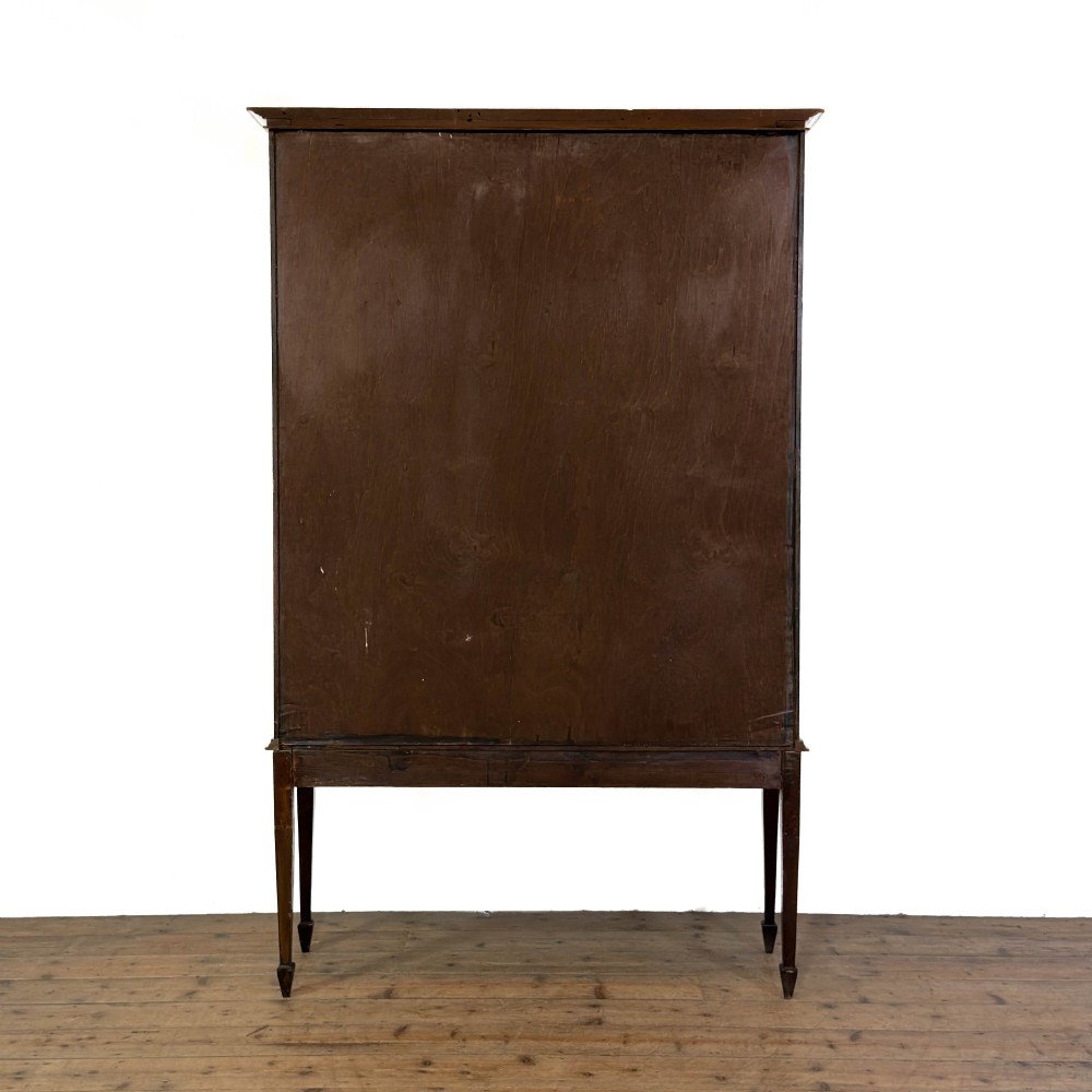 An Edwardian mahogany display cabinet featuring a central bow-front glazed door with marquetry inlay flanked by two side glazed panels. View VI