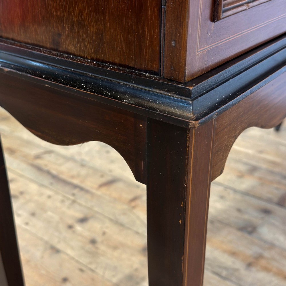 An Edwardian mahogany display cabinet featuring a central bow-front glazed door with marquetry inlay flanked by two side glazed panels. View VIII