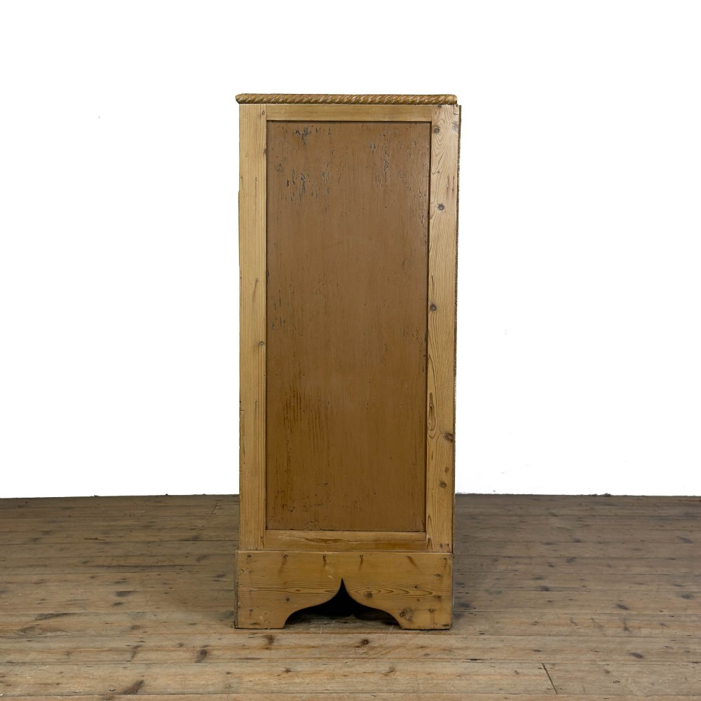 A Victorian stripped pine chest of drawers featuring a two-over-three drawer configuration, brass drop handles, and a shaped apron. View II