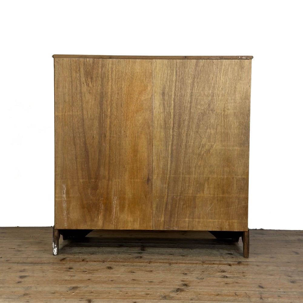 A Victorian stripped pine chest of drawers featuring a two-over-three drawer configuration, brass drop handles, and a shaped apron. View IV