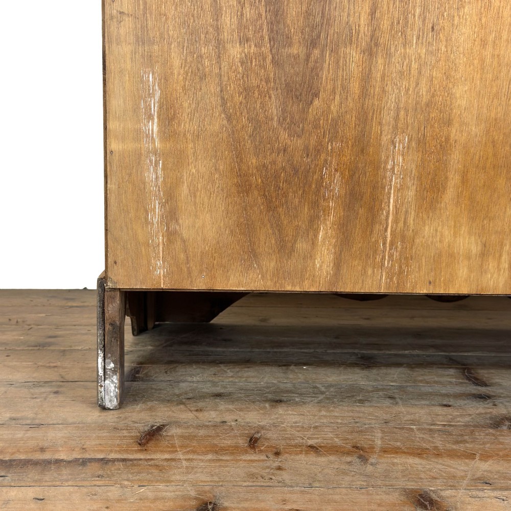 A Victorian stripped pine chest of drawers featuring a two-over-three drawer configuration, brass drop handles, and a shaped apron. View IX