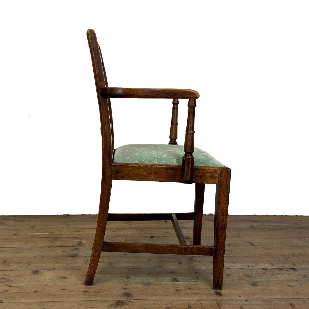 A set of six antique oak dining chairs, including two carvers, featuring geometric inlaid crest rails, decorative back splats, and light green patterned fabric seats. View VIII