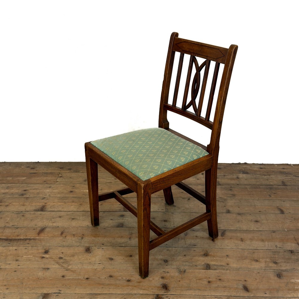 A set of six antique oak dining chairs, including two carvers, featuring geometric inlaid crest rails, decorative back splats, and light green patterned fabric seats. View XIV