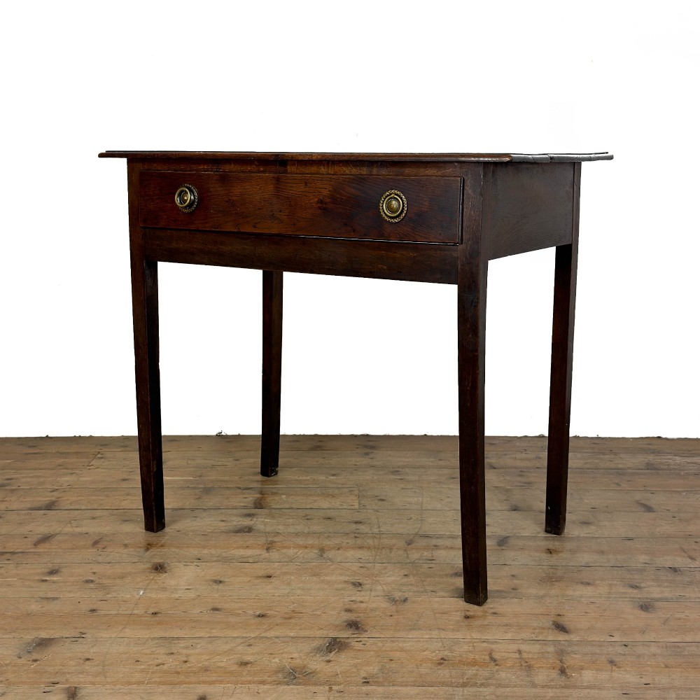 An antique dark oak lowboy side table featuring a single full-width drawer with circular brass handles and straight square legs. View II