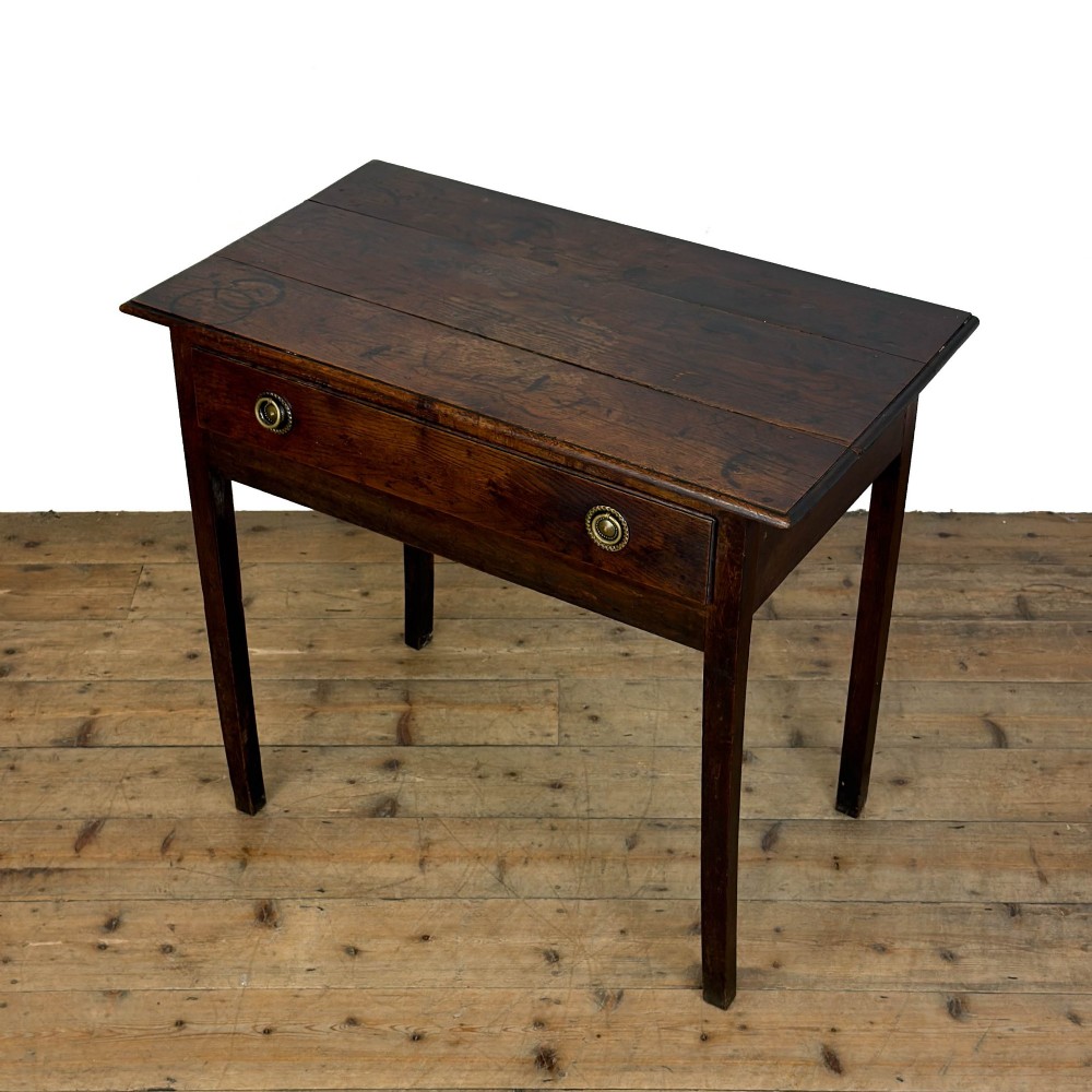 An antique dark oak lowboy side table featuring a single full-width drawer with circular brass handles and straight square legs. View III