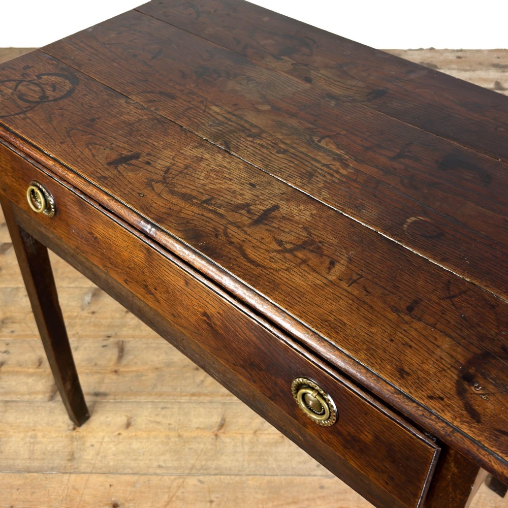 An antique dark oak lowboy side table featuring a single full-width drawer with circular brass handles and straight square legs. View IV