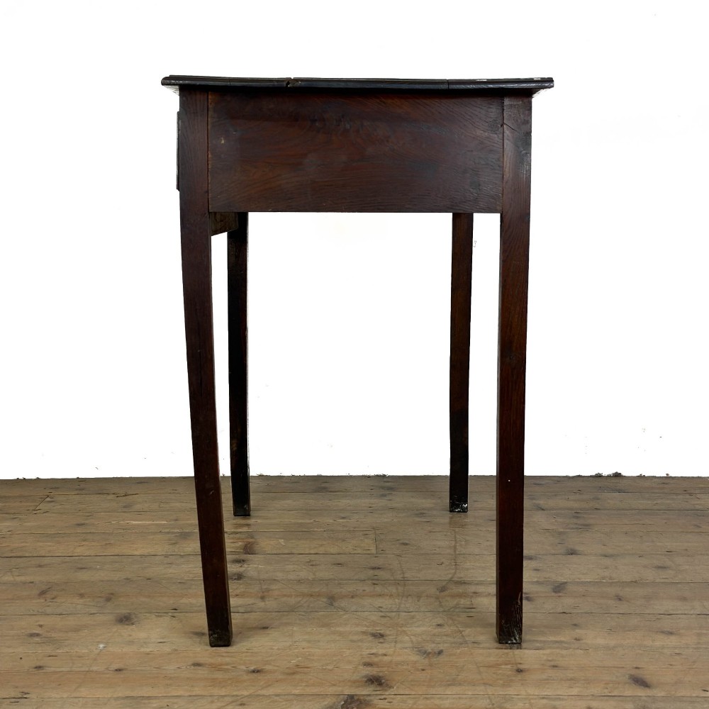An antique dark oak lowboy side table featuring a single full-width drawer with circular brass handles and straight square legs. View V