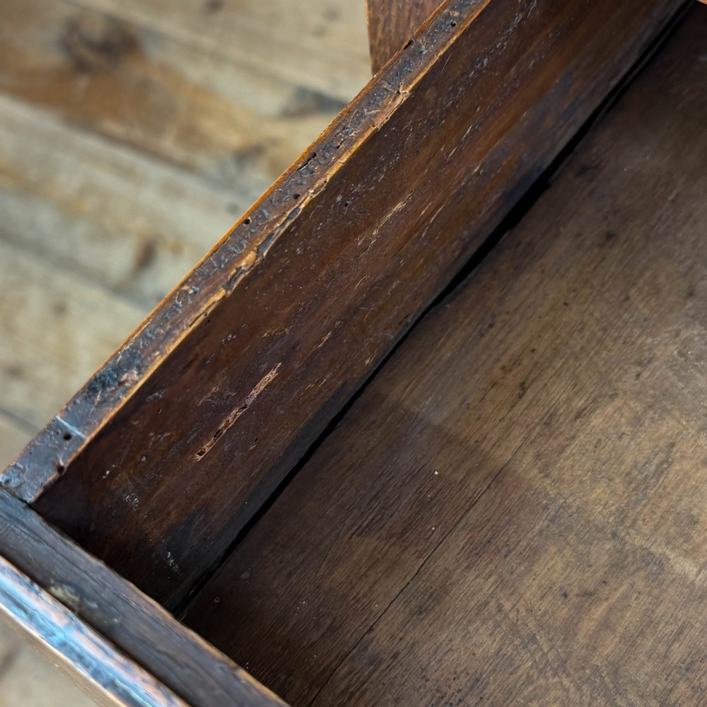 An antique dark oak lowboy side table featuring a single full-width drawer with circular brass handles and straight square legs. View VI