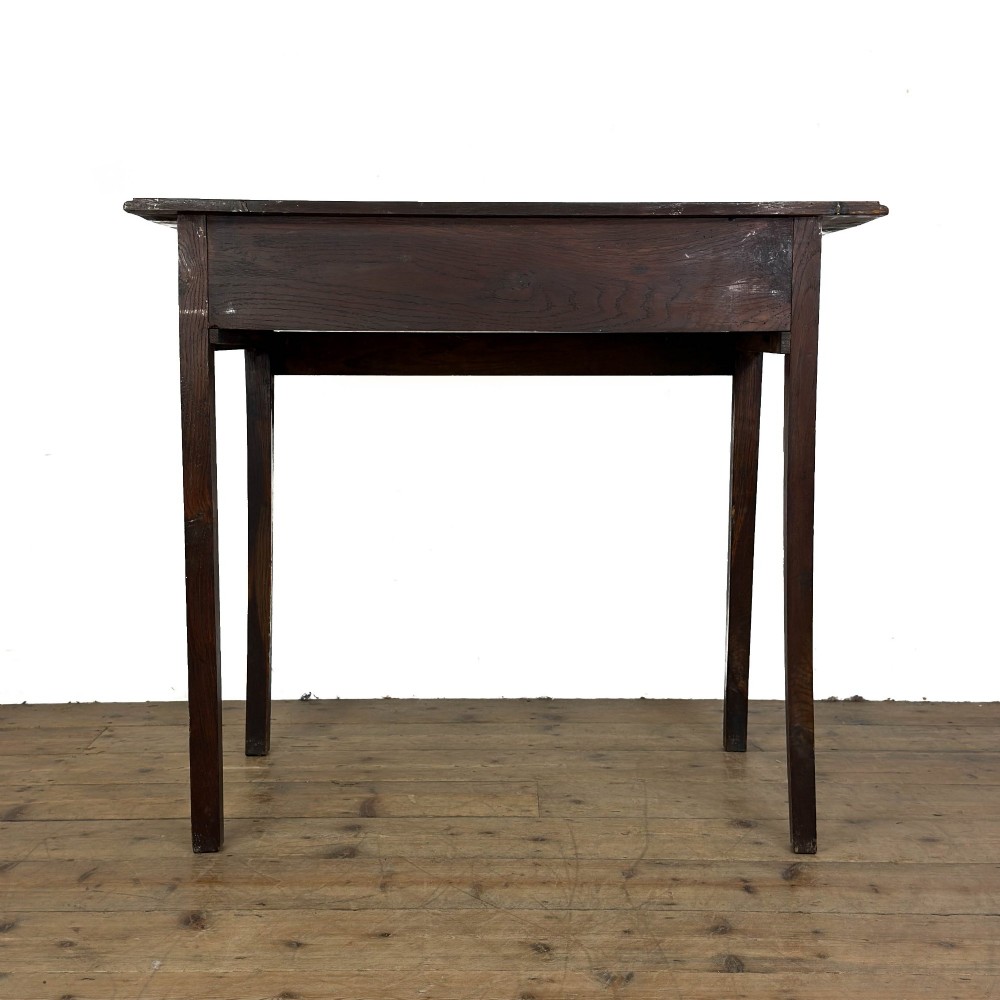 An antique dark oak lowboy side table featuring a single full-width drawer with circular brass handles and straight square legs. View VII