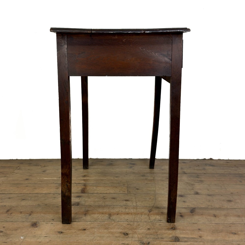 An antique dark oak lowboy side table featuring a single full-width drawer with circular brass handles and straight square legs. View IX