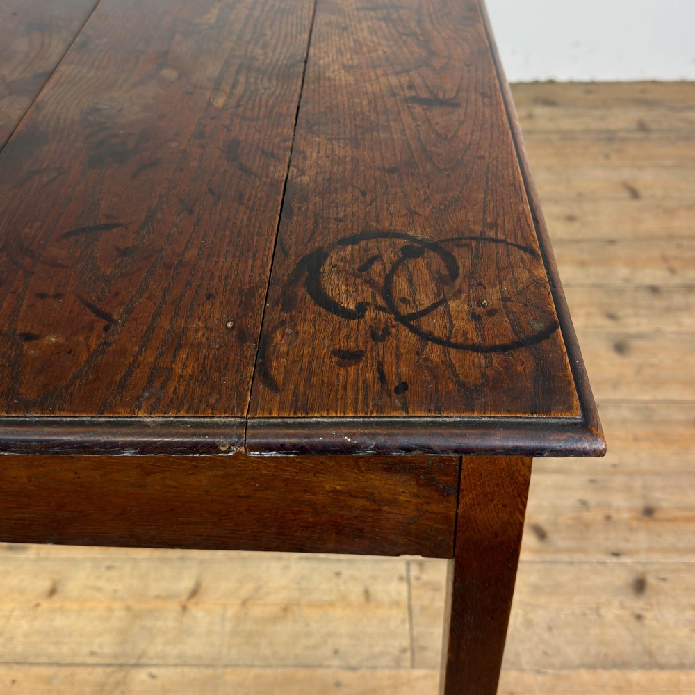 An antique dark oak lowboy side table featuring a single full-width drawer with circular brass handles and straight square legs. View X