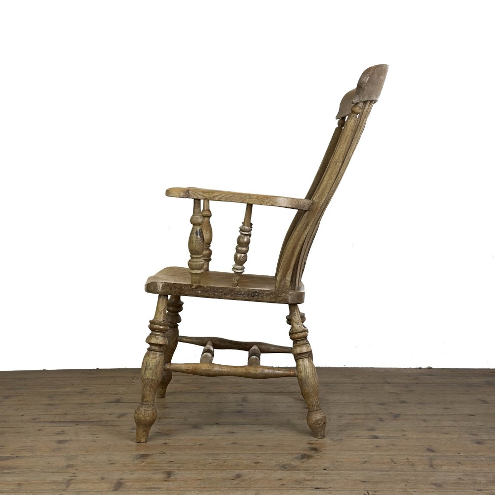 A traditional wooden Windsor armchair featuring a pierced back splat, turned arm supports, and a shaped saddle seat. View III