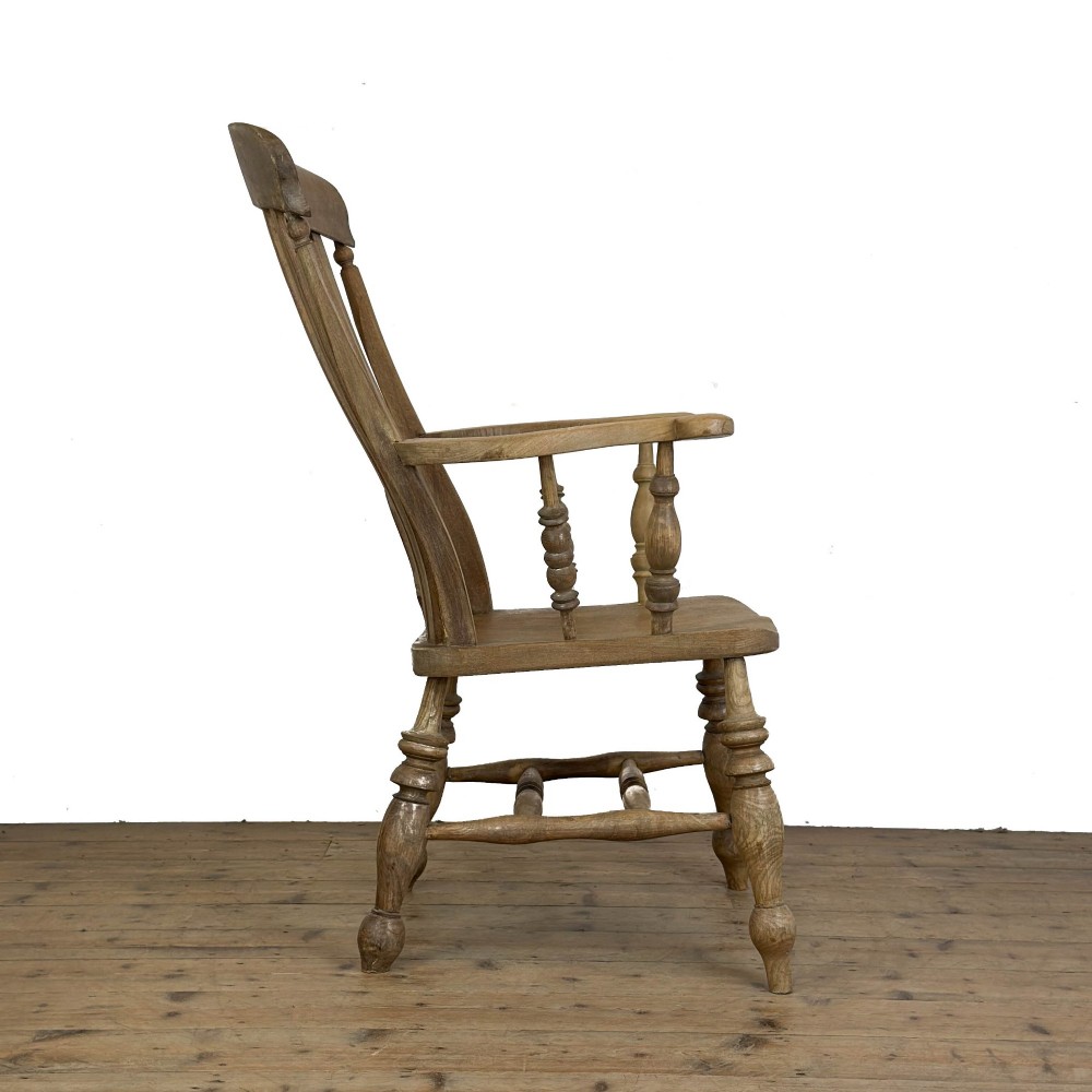 A traditional wooden Windsor armchair featuring a pierced back splat, turned arm supports, and a shaped saddle seat. View IV