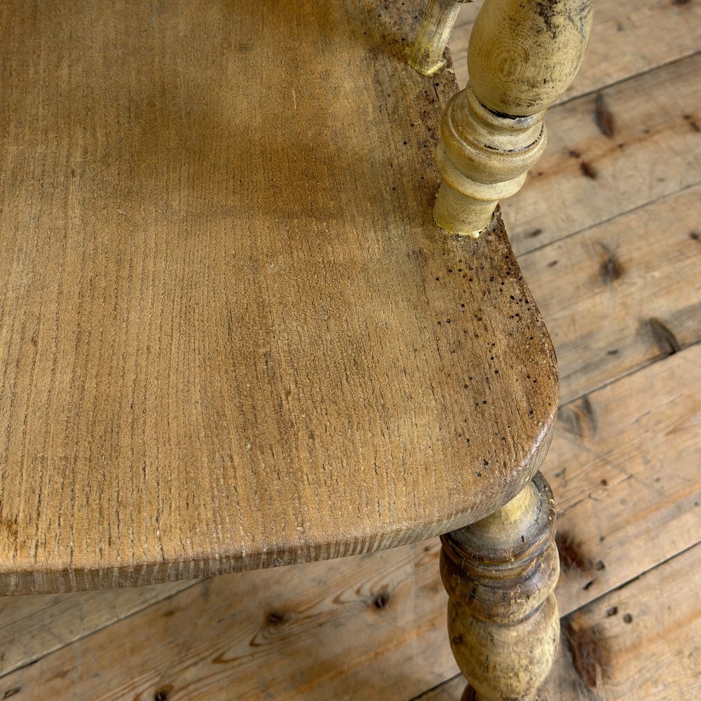 A traditional wooden Windsor armchair featuring a pierced back splat, turned arm supports, and a shaped saddle seat. View V