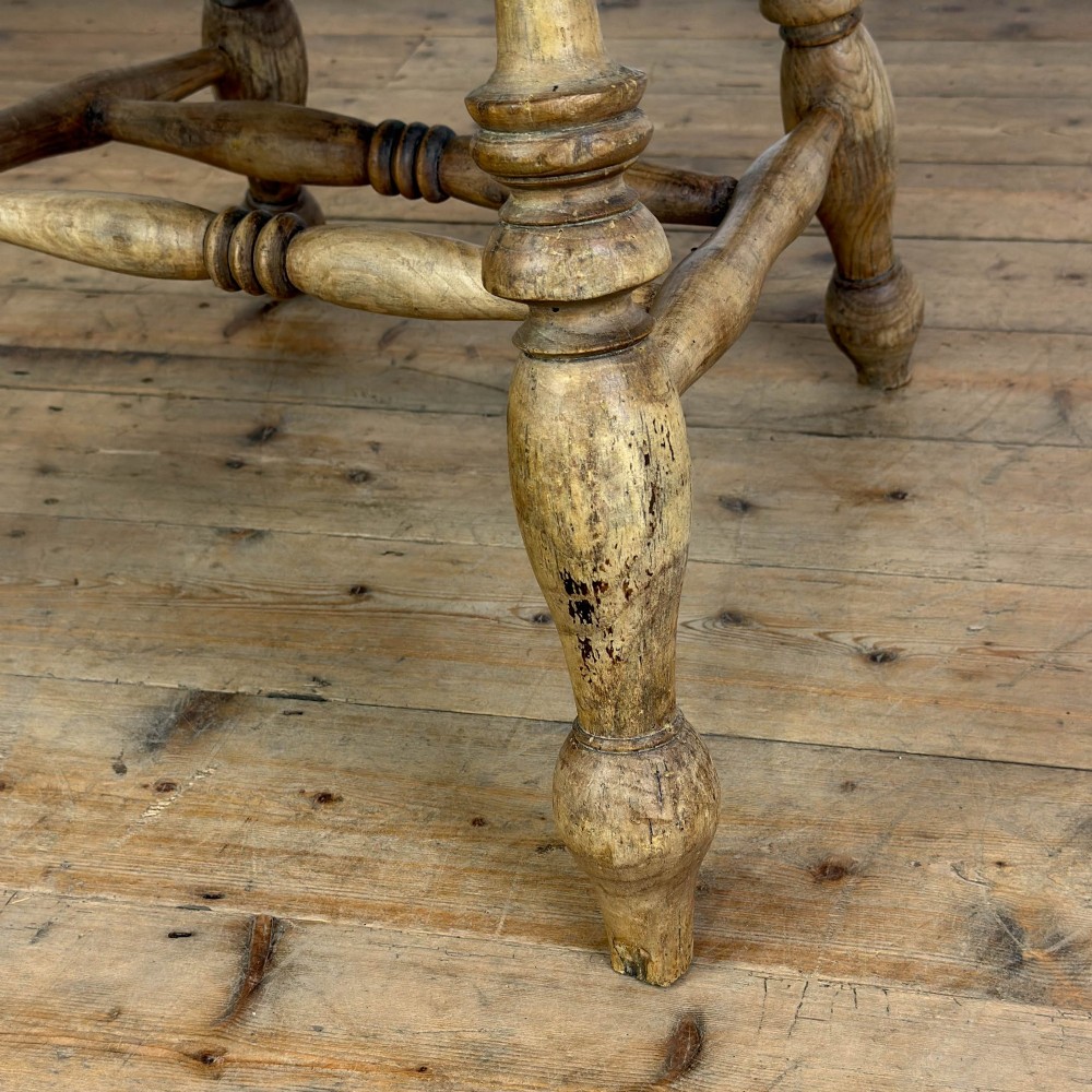 A traditional wooden Windsor armchair featuring a pierced back splat, turned arm supports, and a shaped saddle seat. View VI