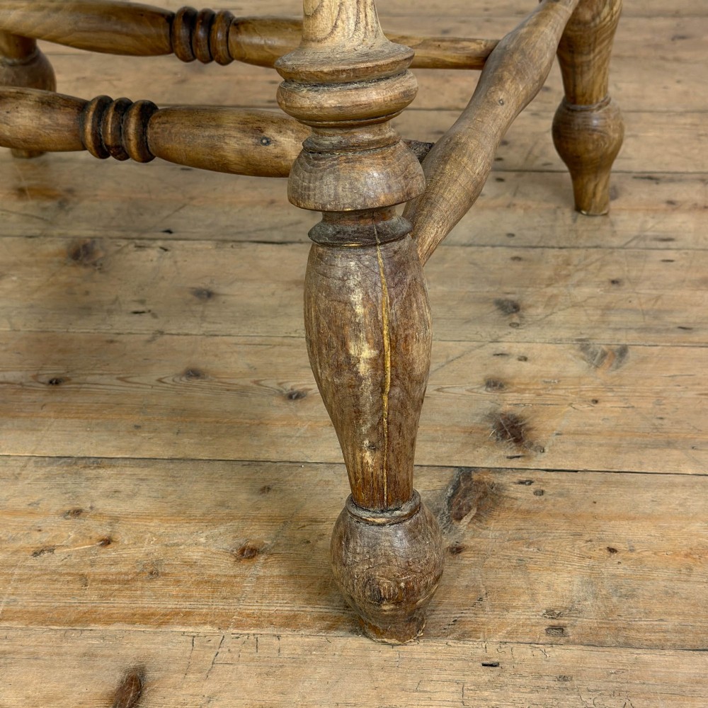 A traditional wooden Windsor armchair featuring a pierced back splat, turned arm supports, and a shaped saddle seat. View VII