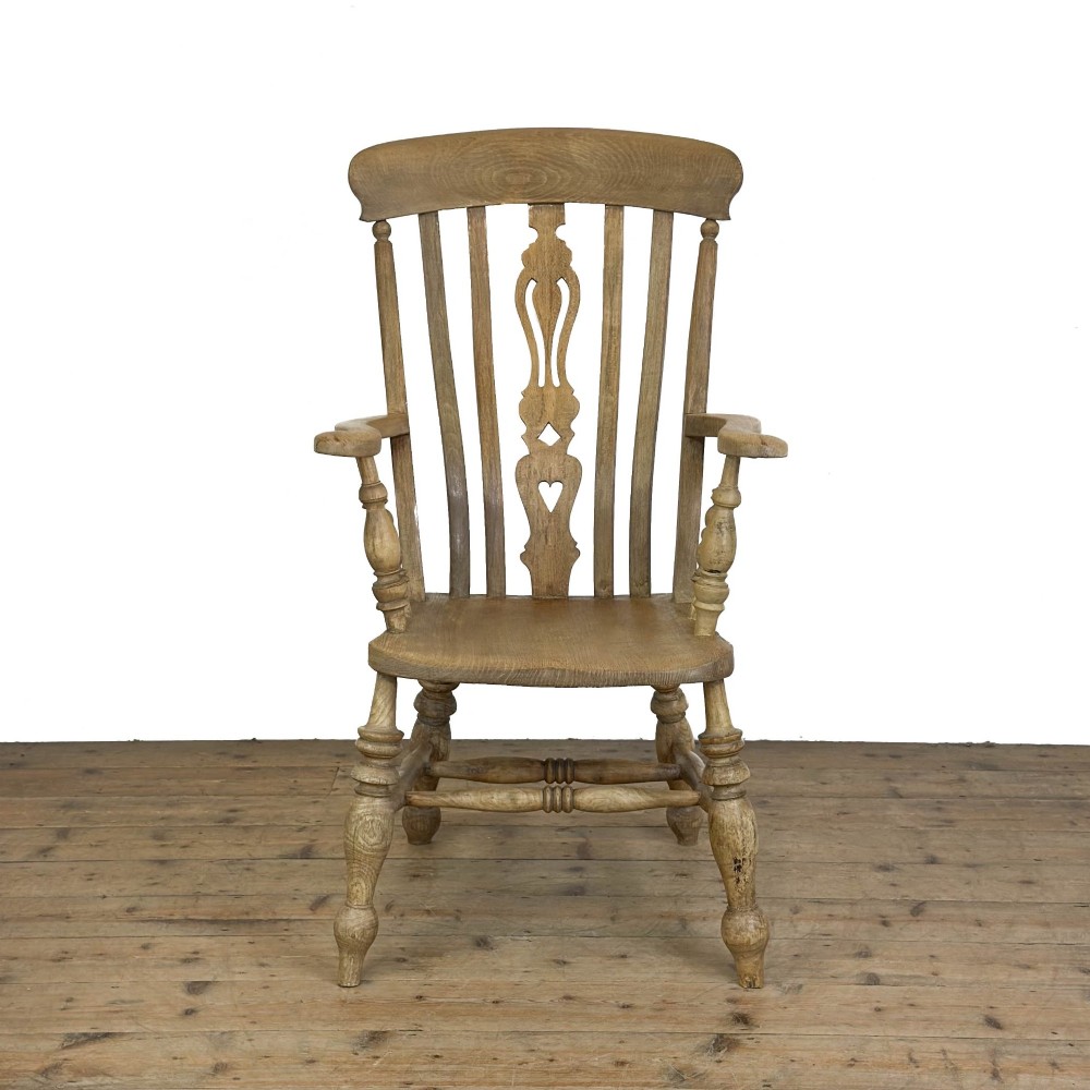 A traditional wooden Windsor armchair featuring a pierced back splat, turned arm supports, and a shaped saddle seat. View VIII