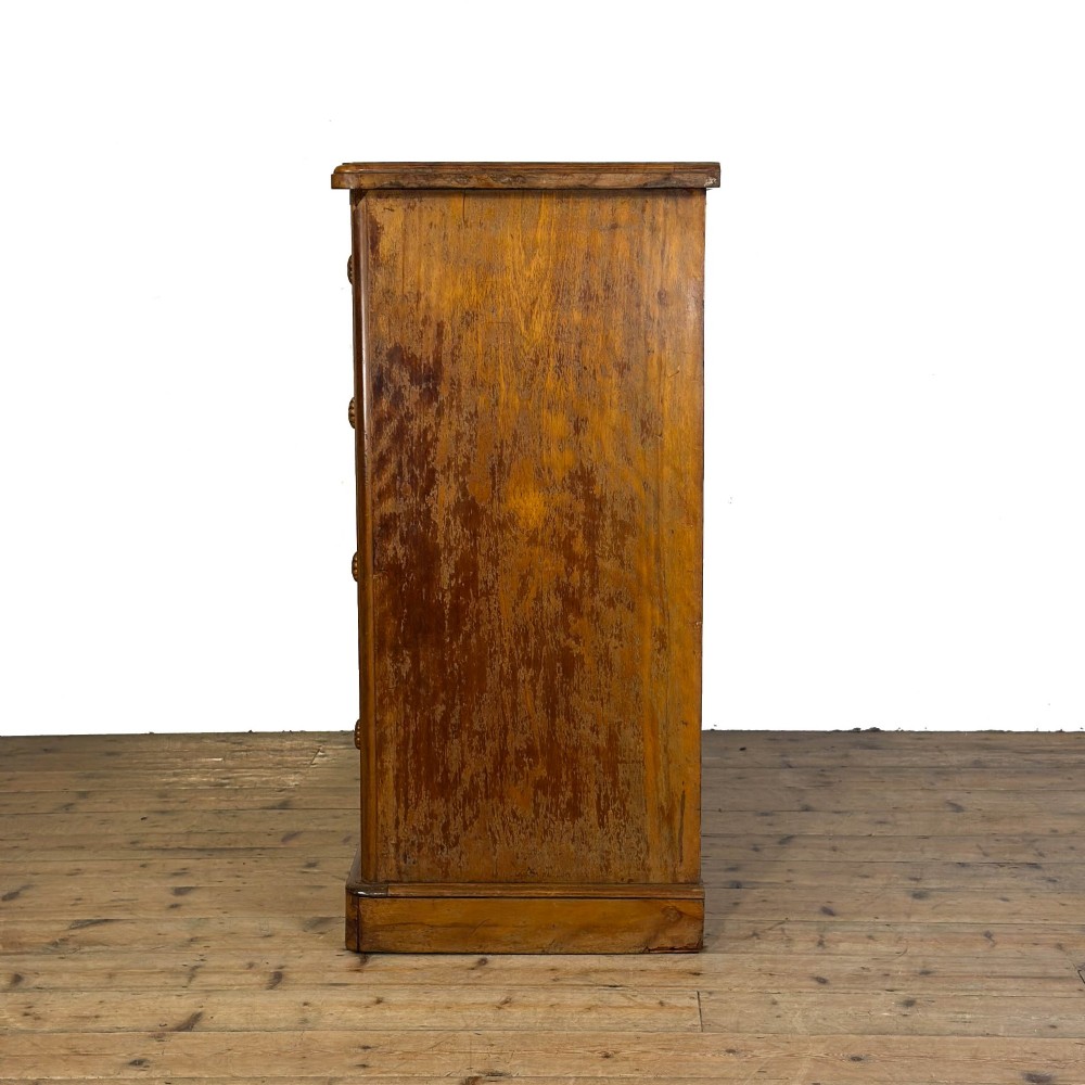 A Victorian mahogany chest of drawers featuring two short over three long drawers with carved fluted knobs and a plinth base. View V