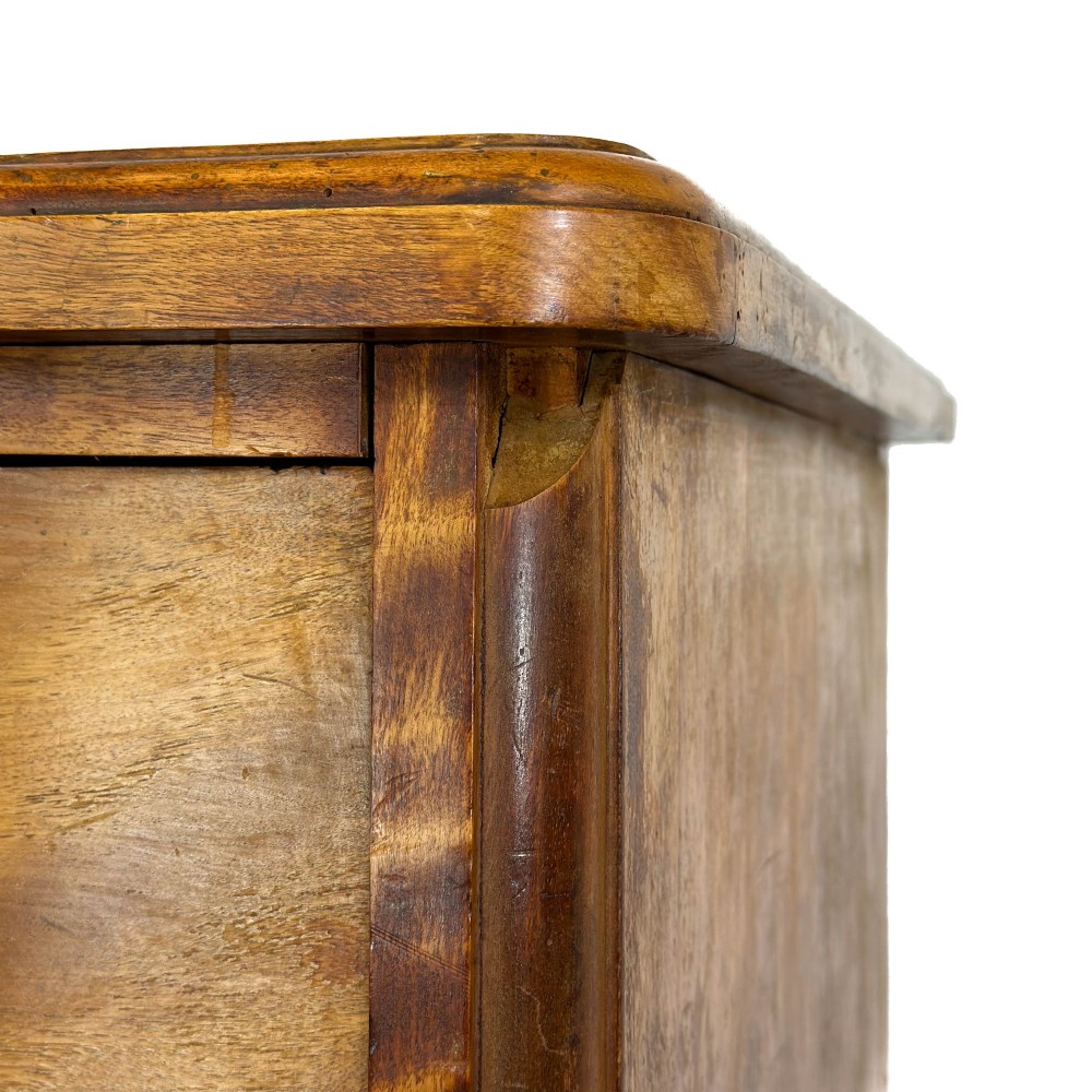A Victorian mahogany chest of drawers featuring two short over three long drawers with carved fluted knobs and a plinth base. View VIII