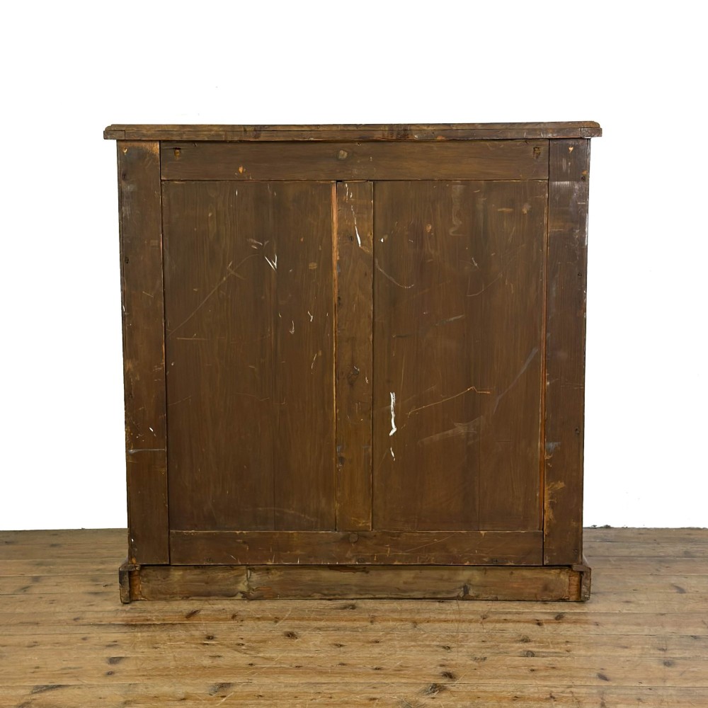 A Victorian mahogany chest of drawers featuring two short over three long drawers with carved fluted knobs and a plinth base. View X